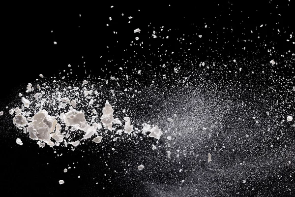 Flour in freeze motion over black — Stock Photo, Image