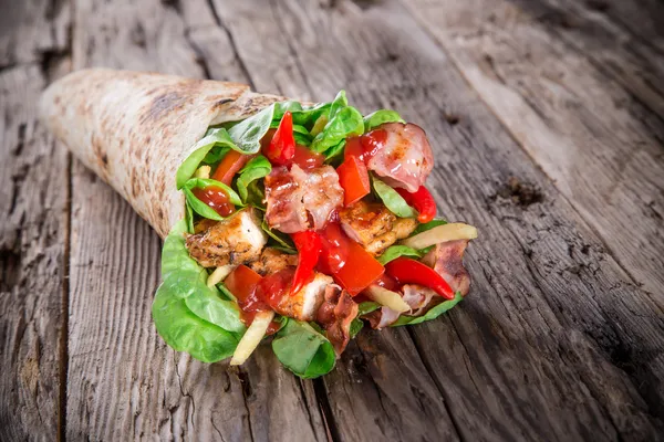 Chicken strips in a Tortilla Wrap on wood. — Stock Photo, Image