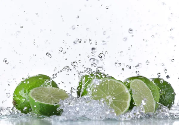 Limes with water splash — Stock Photo, Image