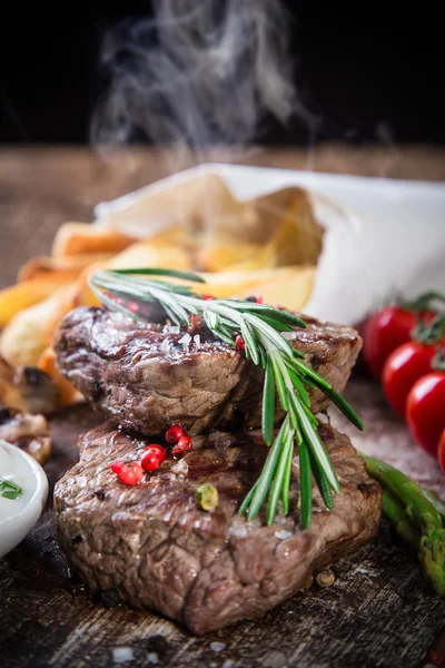 Bife de carne em mesa de madeira — Fotografia de Stock