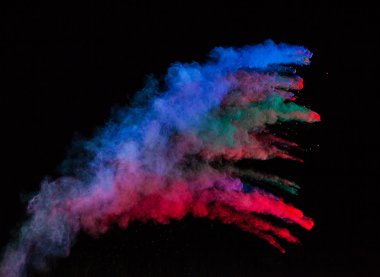 Colored powder in abstract shape isolated on black background clipart