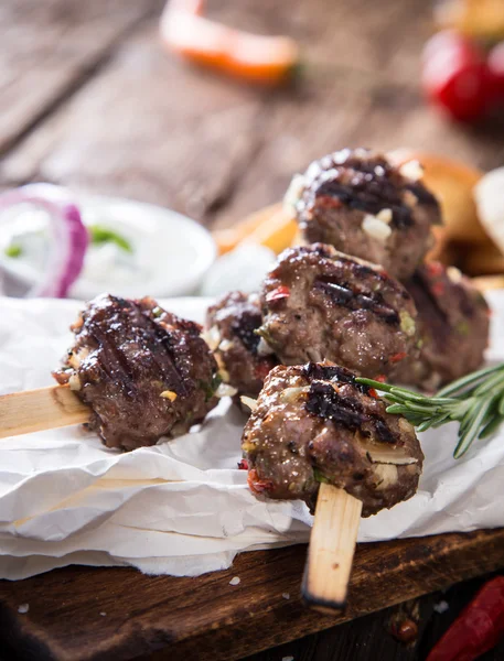 Delicious kebab on wooden table — Stock Photo, Image