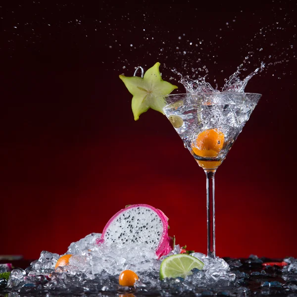 Fresh fruit cocktail in freeze motion splashing — Stock Photo, Image