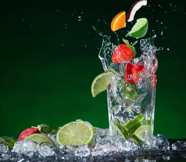 Fresh fruit cocktail in freeze motion splashing — Stock Photo, Image