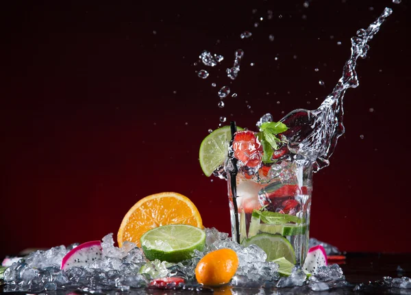 Fresh fruit cocktail in freeze motion splashing — Stock Photo, Image