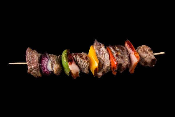 Tasty skewer on black background — Stock Photo, Image