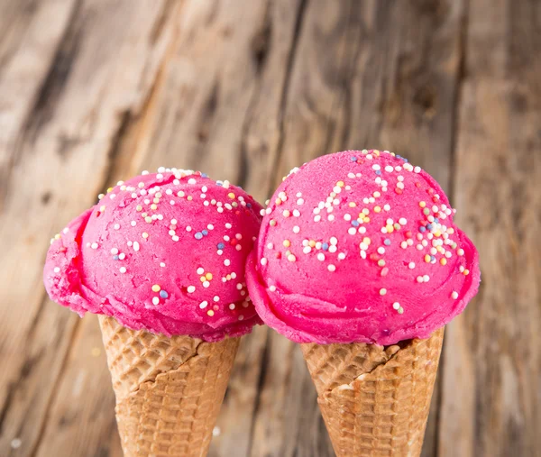 Ice cream scoops on wooden table — Stock Photo, Image