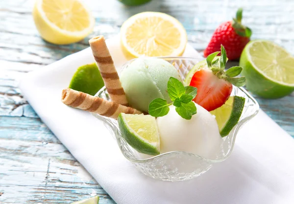 Ice cream scoops on wooden table — Stock Photo, Image