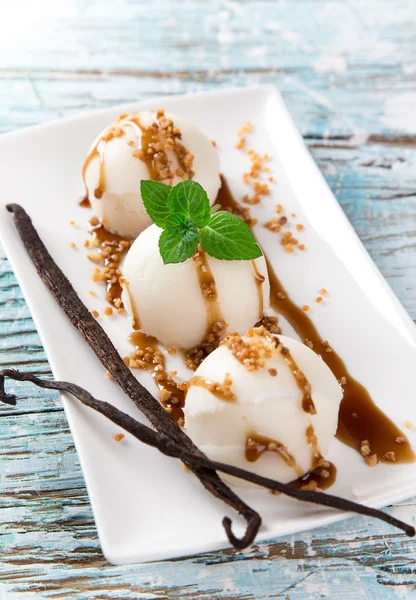 Ice cream scoops on wooden table — Stock Photo, Image