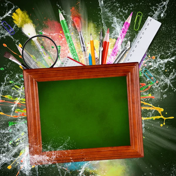 Wooden blackboard with school supplies — Stock Photo, Image