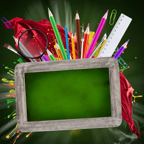 Wooden blackboard with school supplies — Stock Photo, Image