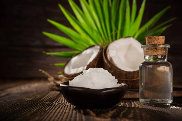 Coconut pieces isolated on wooden background — Stock Photo, Image