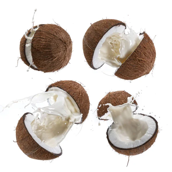 Prasklý kokos s mléčným šplouchnutím ve vzduchu. — Stock fotografie