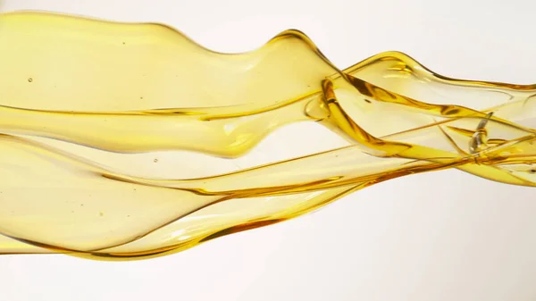 Tekoucí olej na bílém pozadí — Stock fotografie