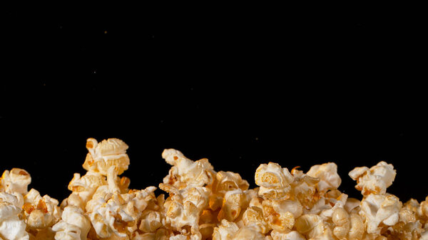 Popcorn on Black Background. Stock Photo