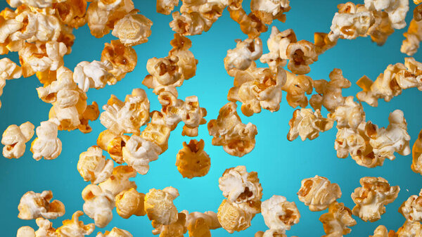 Freeze Motion of Popcorn Flying on Gradient Blue Background. Stock Photo