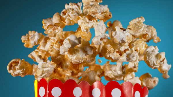 Freeze Motion of Popcorn Flying on Gradient Blue Background. Royalty Free Stock Photos
