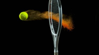 Freeze Motion Shot of Racket Hitting Tenis Ball Containing Orange Powder clipart