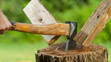 Freeze motion of chopping wooden logs with axe.