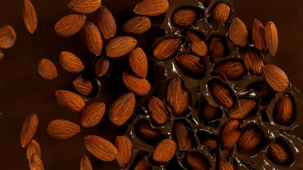 Falling Almonds Dark Hot Melted Chocolate Close Top Shot — Foto de Stock