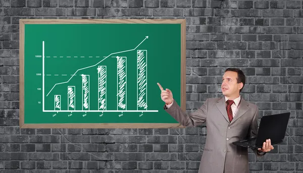 Man pointing to chart — Stock Photo, Image