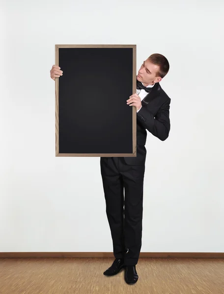 Businessman holding blackboard — Stock Photo, Image