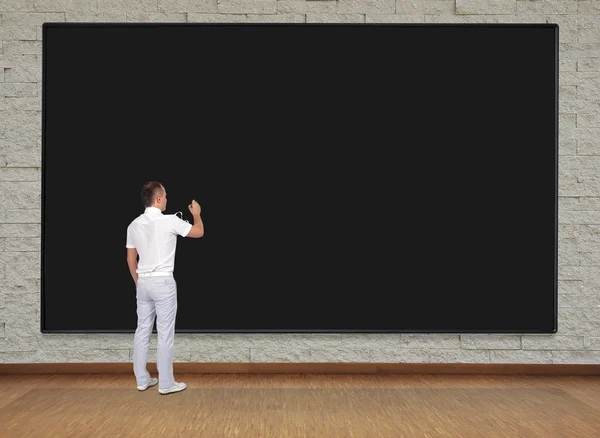 Man drawing on blackboard — Stock Photo, Image