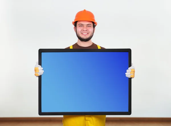 Builder holding plasma — Stock Photo, Image