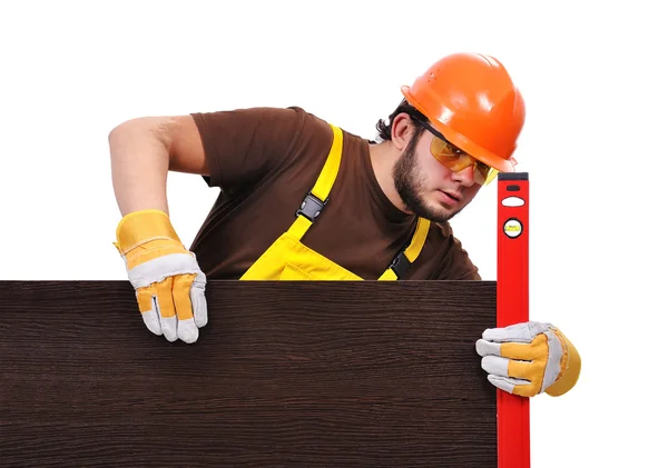 Builder measures the surface on a white background — Stock Photo, Image