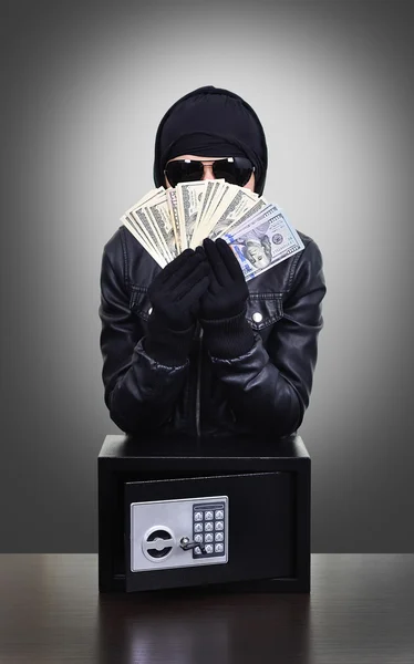 Thief holding dollars — Stock Photo, Image