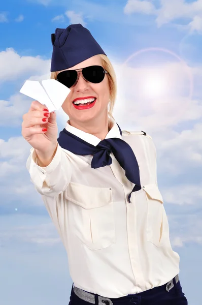 Stewardess holding paper airplane — Stock Photo, Image