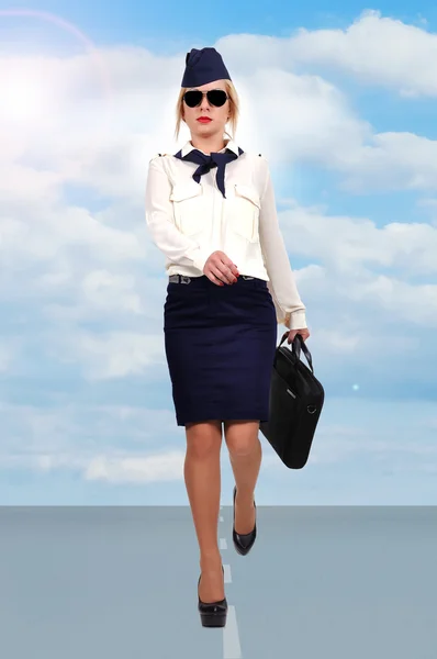 Stewardess walking on runway — Stock Photo, Image