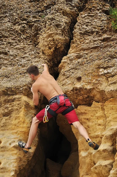 Man climbing on rock Stock Picture