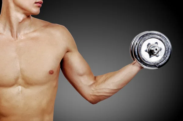 Muscular guy with dumbbells — Stock Photo, Image