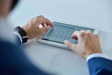 Dijital tablet bilgisayar kullanan yönetici ellerinin üst görünümü. İş ve yönetim kavramı. Kapat.