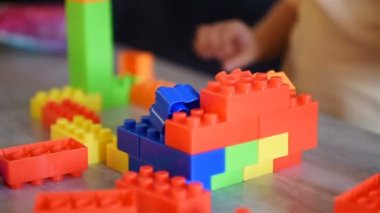 Little Baby Playing On Table With Colroful Toys. Children Development And Educational Games Concept. Slow Motion Effect.