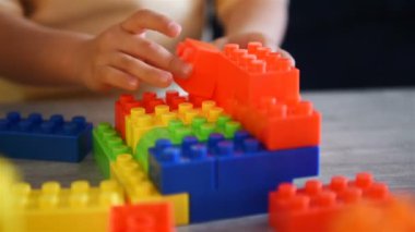 Baby Girl Playing On Table With Colroful Toys. Children Development And Educational Games Concept. Slow Motion Effect.