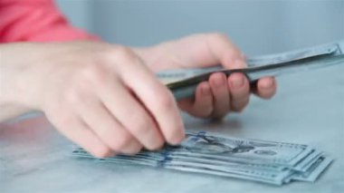 Hands Counting 100 Dollar Banknotes On Table In Office. Business And Finance Concept. Close Up