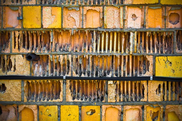 Antigua pared de ladrillo texturizado de amarillo y naranja . —  Fotos de Stock