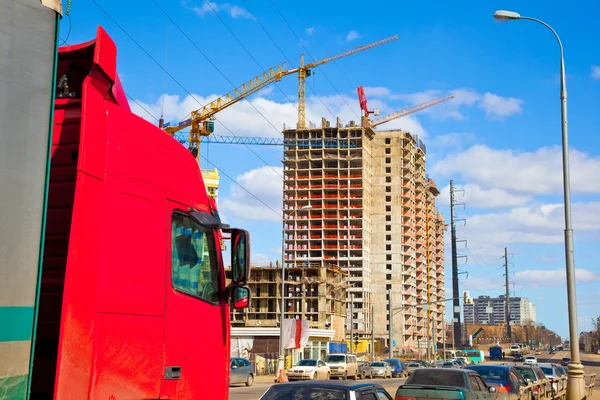 Truck cab red color on a background of construction — Stock Photo, Image