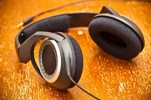 Headphones on old vintage board — Stock Photo, Image