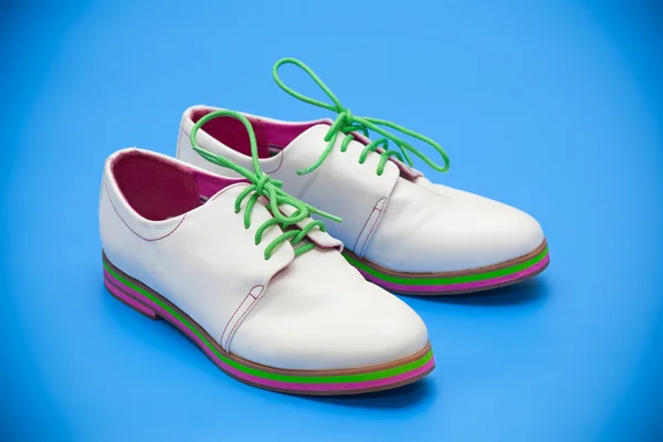 White shoes on a blue background — Stock Photo, Image