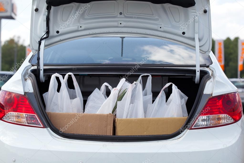 Shopping bags are in the car trunk