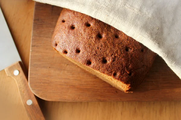 Freshly baked traditional bread on wooden table — Stock Photo, Image