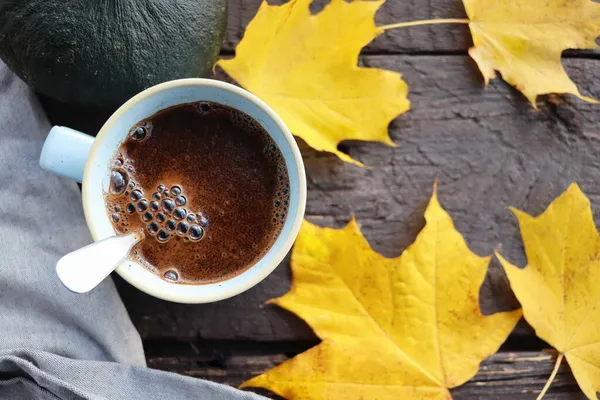 Herbst im Hintergrund. Verschwommenes Herbstlaub und Kürbishintergrund mit heißem Kaffee — Stockfoto