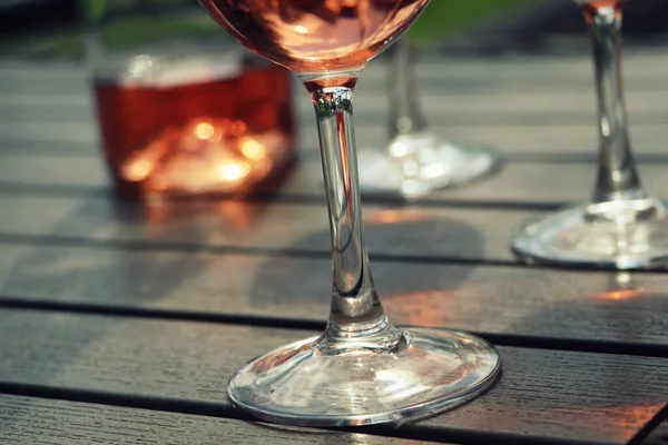 Kompozice s růžovými skleničkami na víno, tmavý hřbet — Stock fotografie