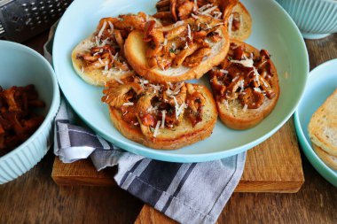 Chanterelle sandwiches with cheese. Open faced sandwich with creamy , seasonings and pepper and herbs on an old wooden background. Mock up. Top view