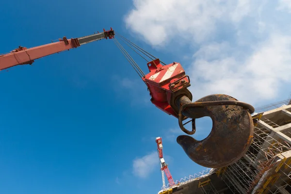 Hook of crane on background construction building — Stock Photo, Image