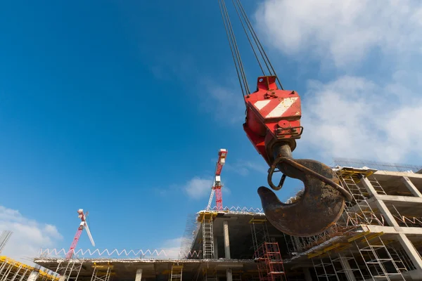 Hook of crane on background building under construction — Stock Photo, Image