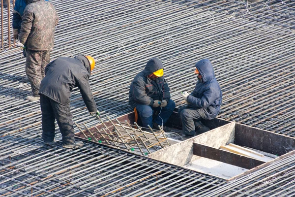 Builders prepare rebar for the foundation of building — Stock Photo, Image